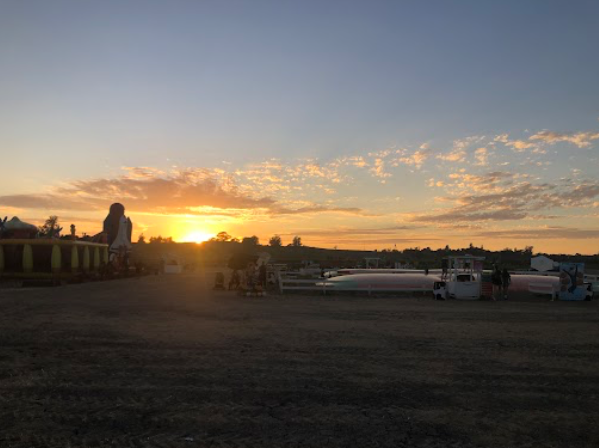 A picture of the sunset at the fair grounds during harvest season (Photo by: Maranda Zwinge).